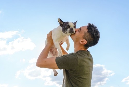 dog owner carrying his dog